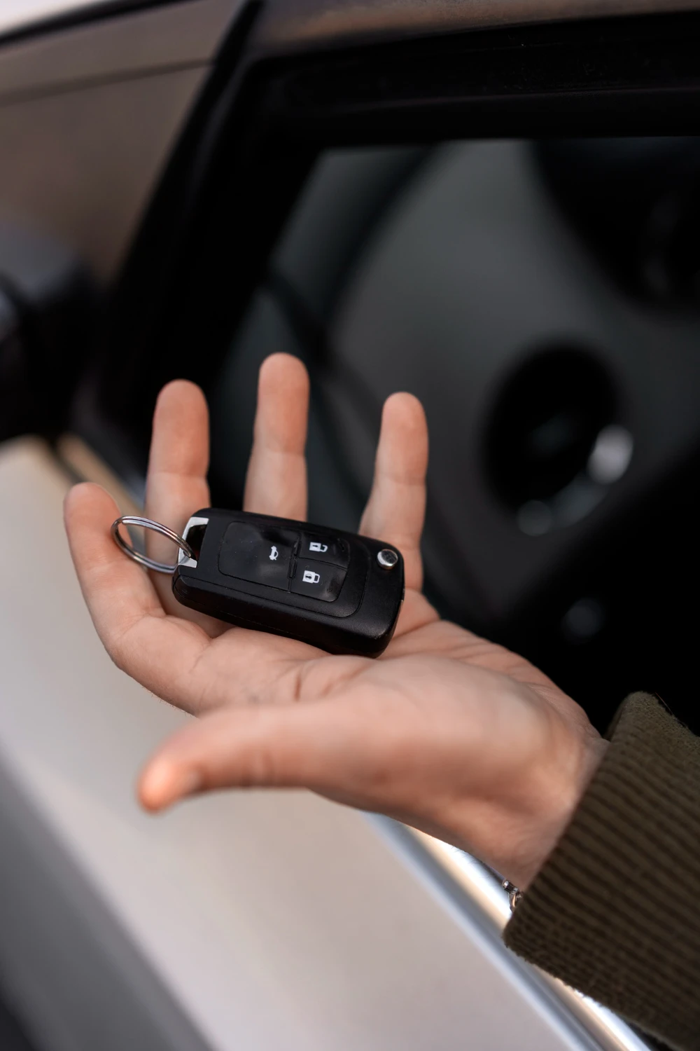 High angle hand holding car key<br />